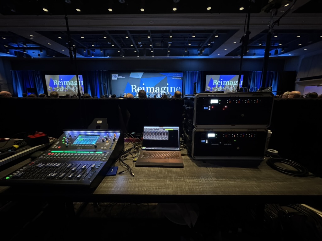 Front-of-house audio and video control position facing a conference stage
