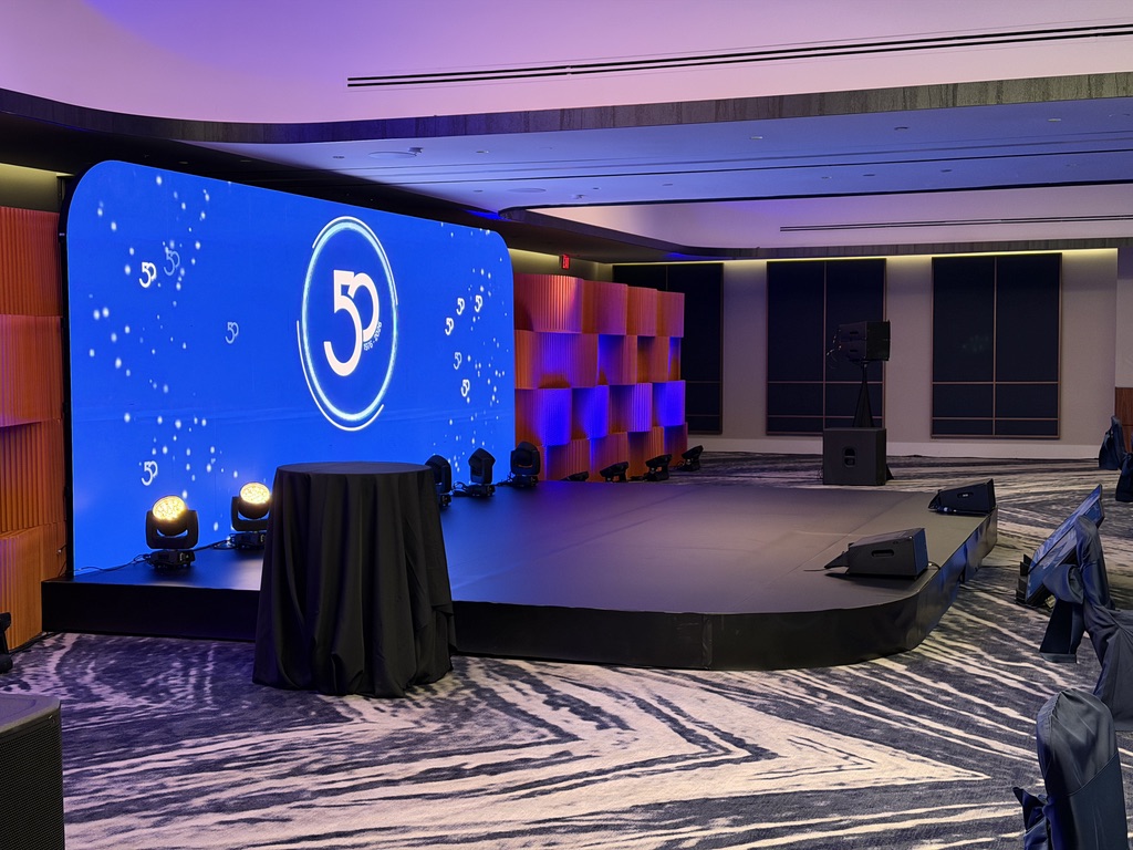 Quadra 50th anniversary stage in Houston with large LED screen