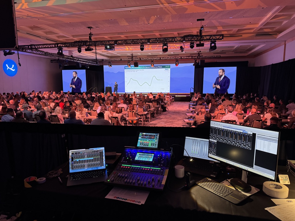 Full conference room at Quadra QCC in Vancouver with stage screens and control desk
